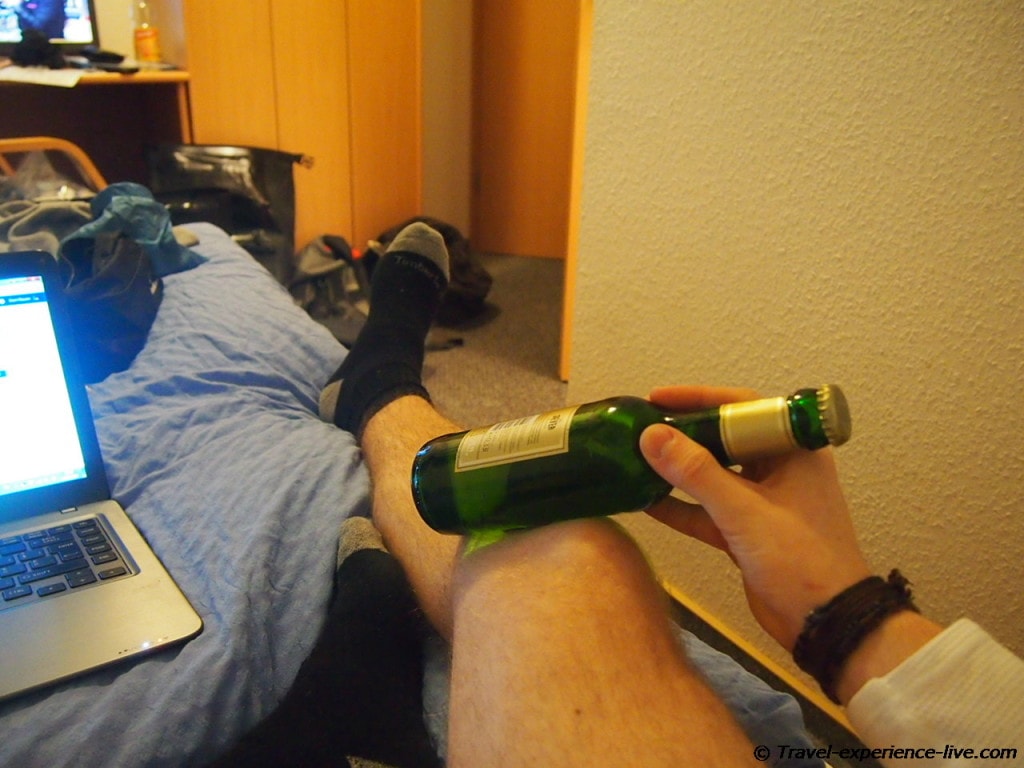 Treating injured knee with cold beer.