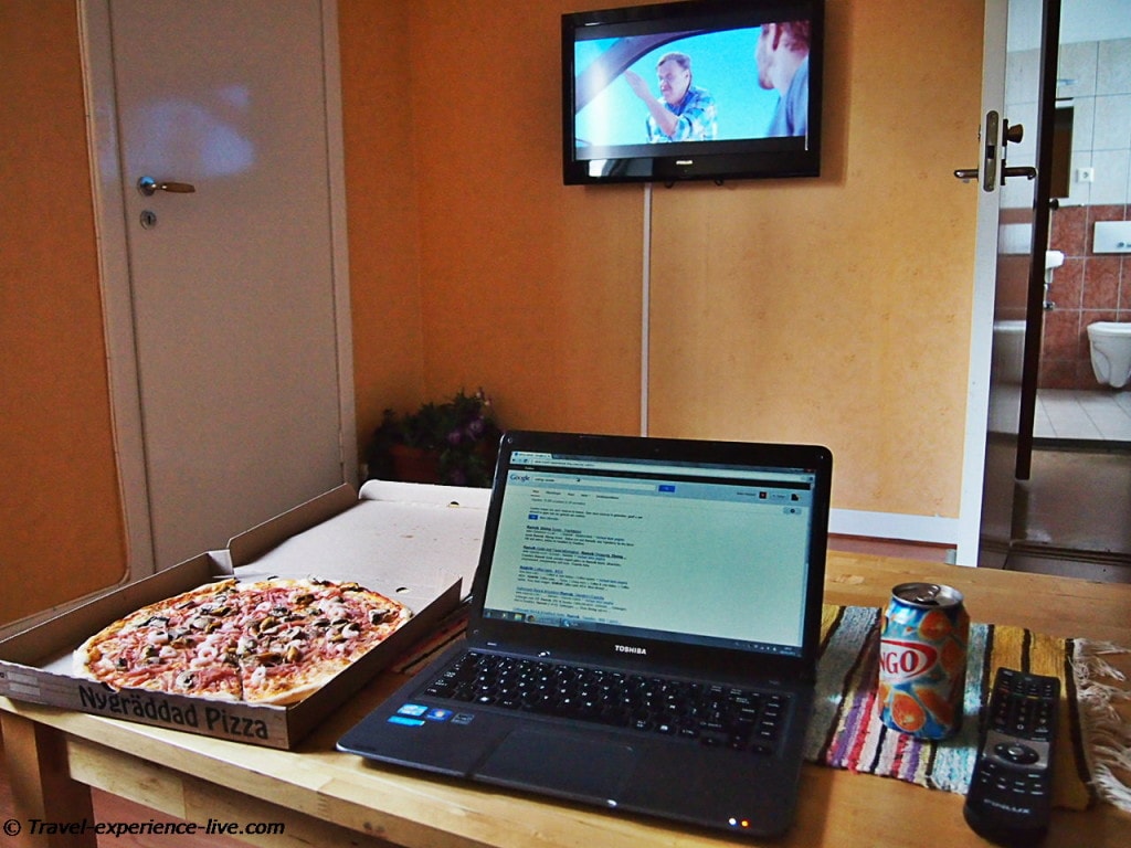 Pizza and TV in hostel, Sweden.