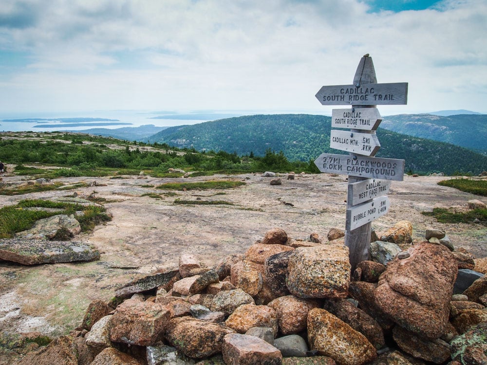 Hiking trail signs on the Cadillac Mountain South Ridge Trail, one of the best day hikes in Acadia National Park