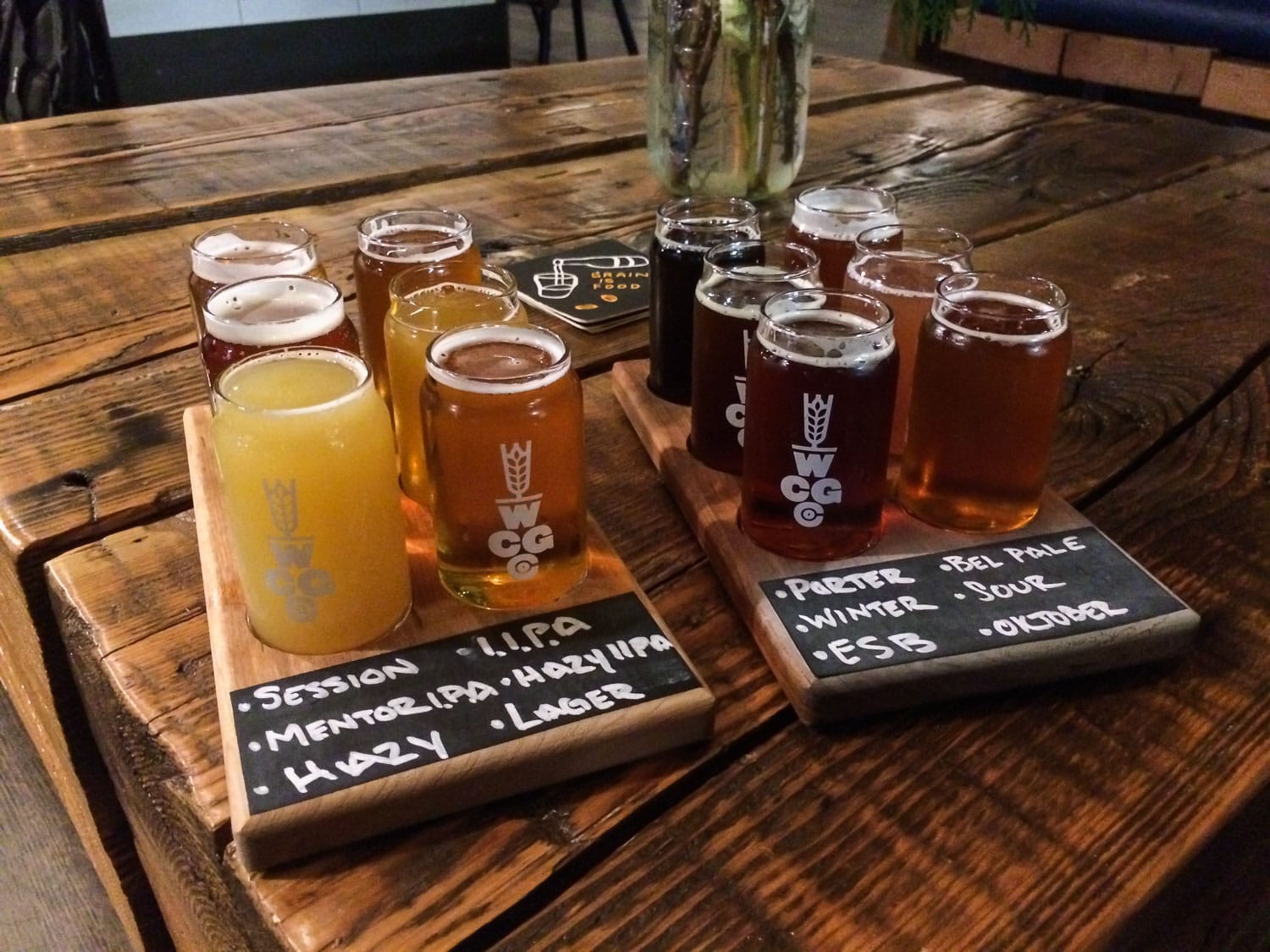 Craft beer flight on wooden table at West Coast Grocery Co. in Portland, Oregon