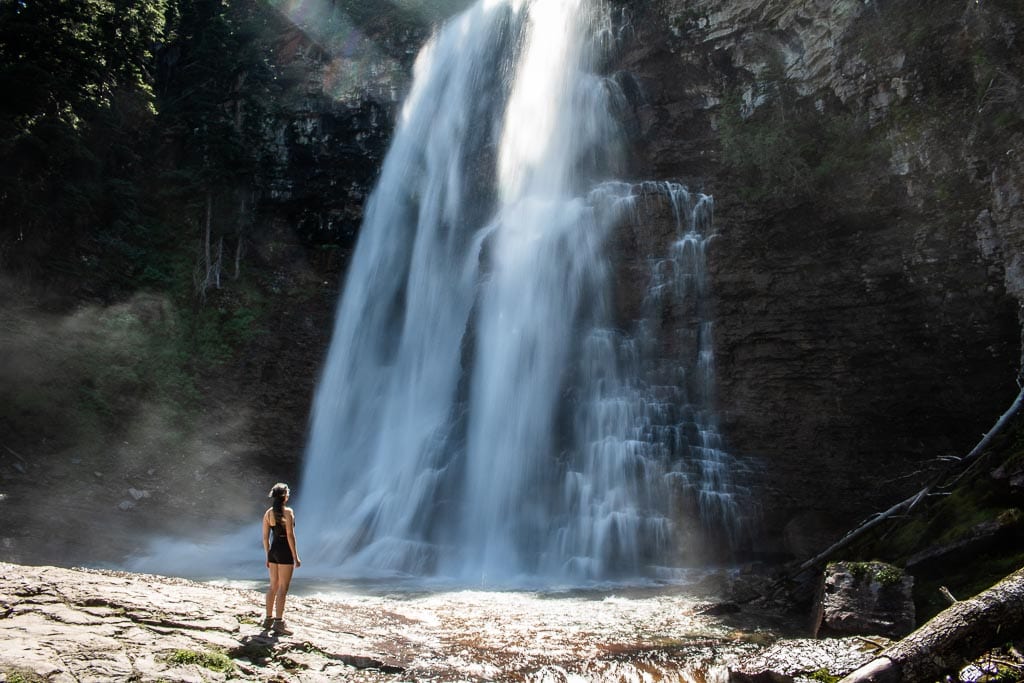 Hiker at Virginia Falls in Glacier National Park, Montana, one of the top waterfall hikes in America's national parks