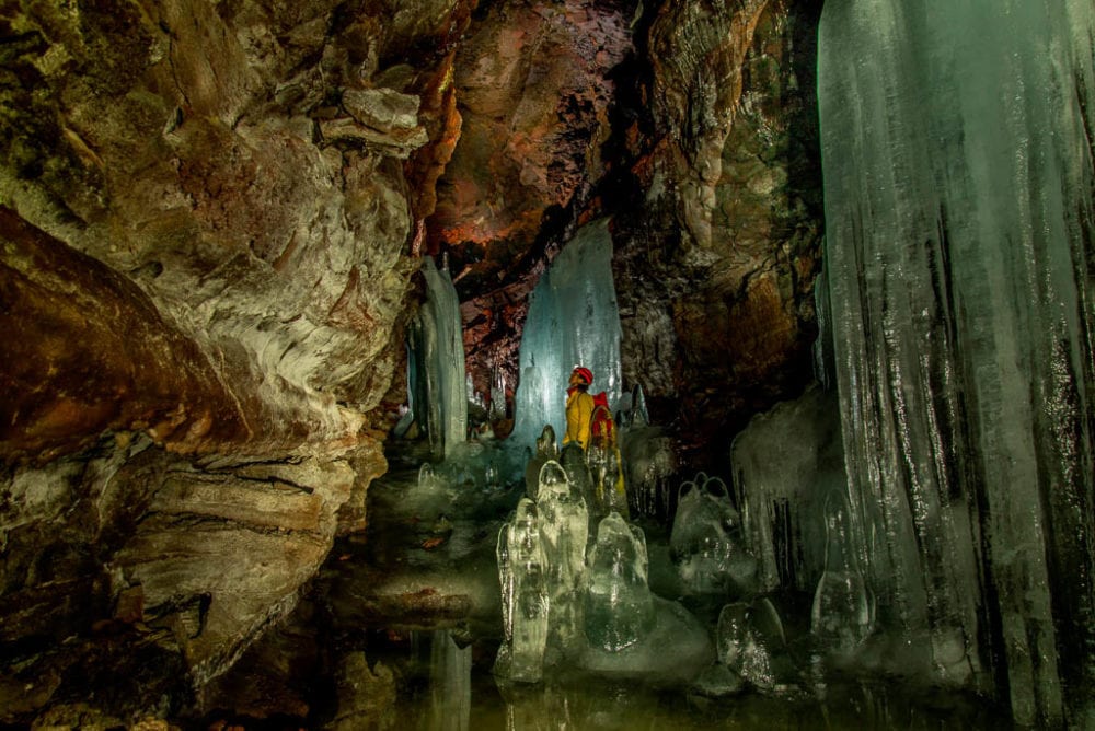 Caver in Crystal Ice Cave, Lava Beds National Monument, California - Image credit NPS