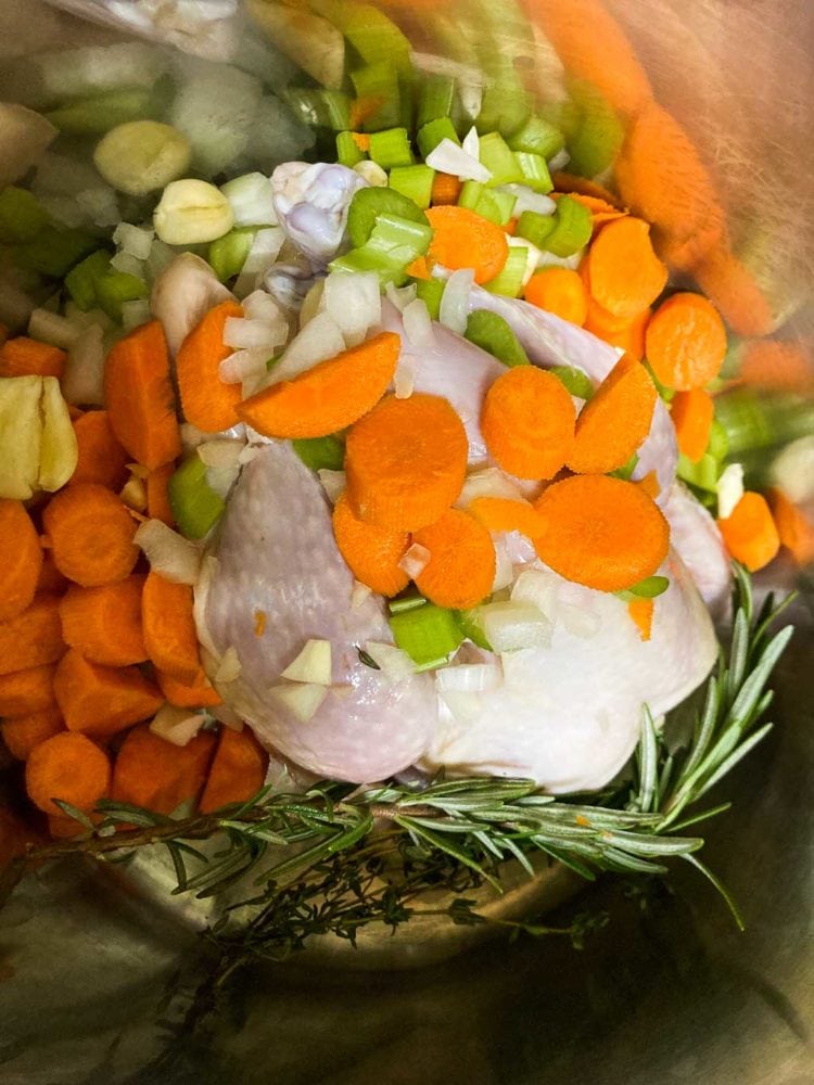 Chicken bog broth ingredients in soup pot