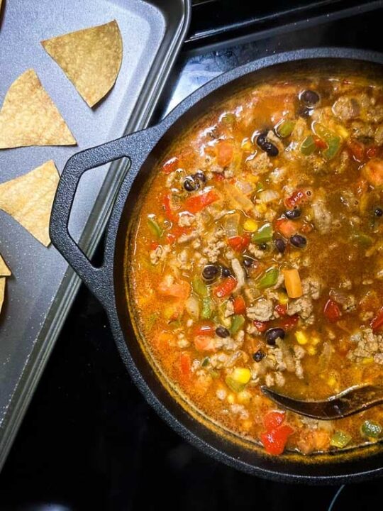 Ground turkey taco soup in pot with baked tortilla chips