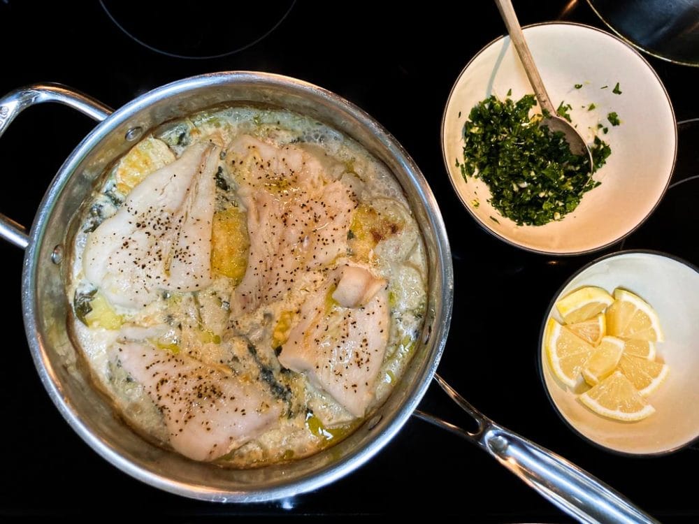 Halibut and scalloped potatoes in pan