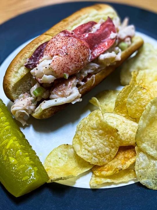 Maine lobster roll recipe with kettle chips and a dill pickle