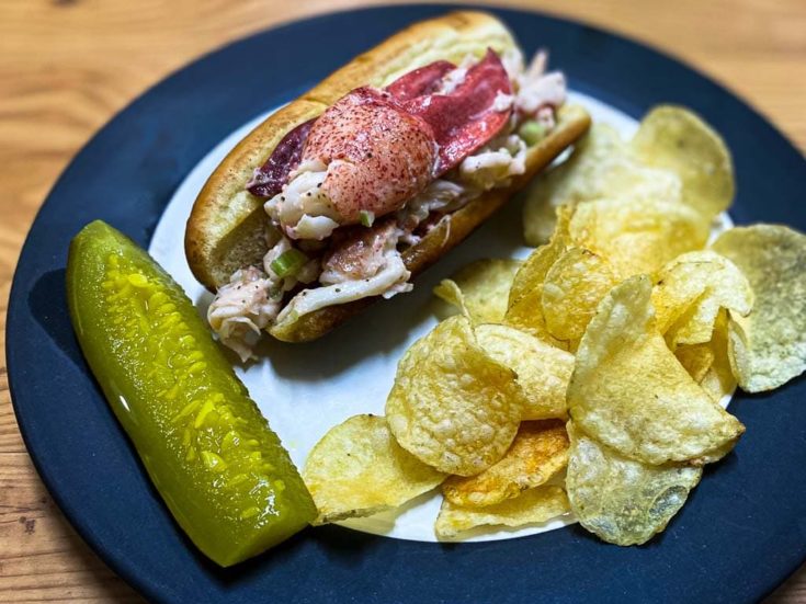 Maine lobster roll recipe with kettle chips and a dill pickle