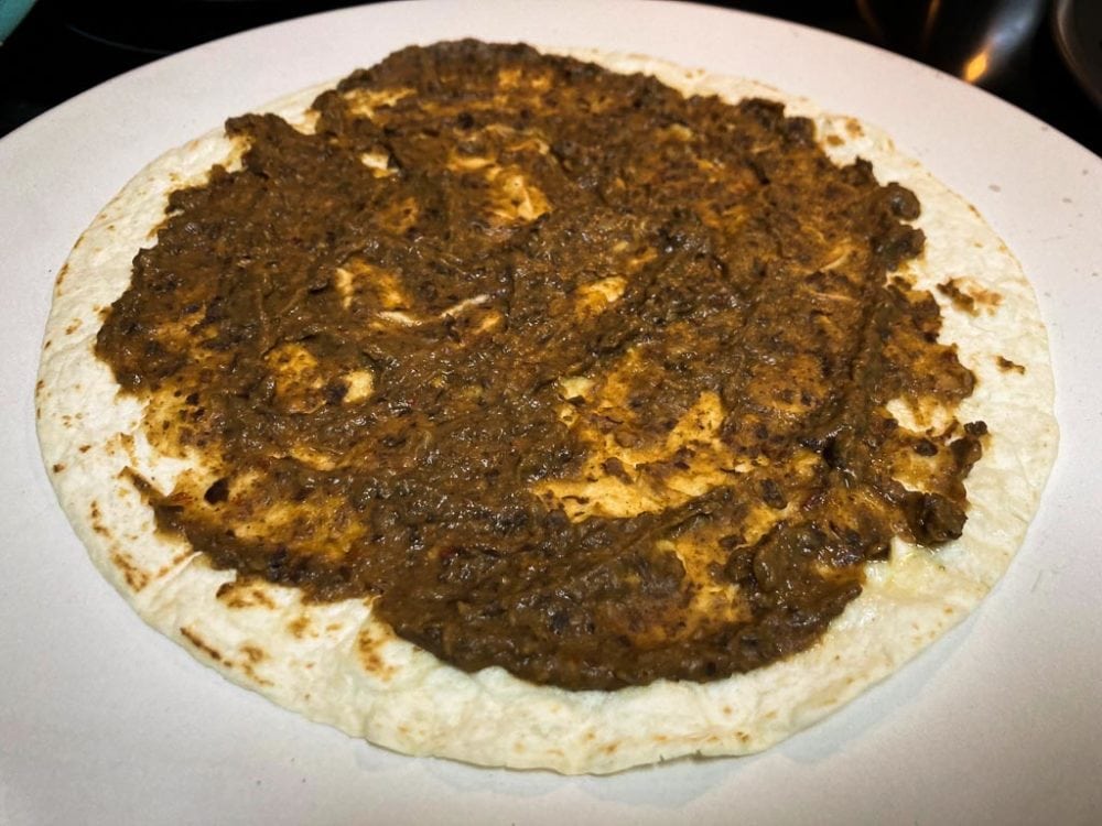 Tortilla pizza with black bean spread