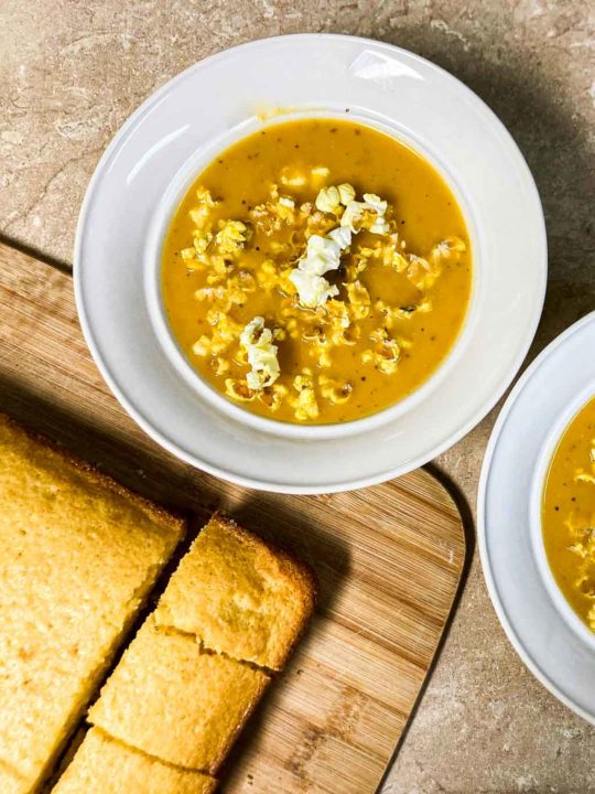 Butternut squash soup recipe topped with popcorn and cornbread