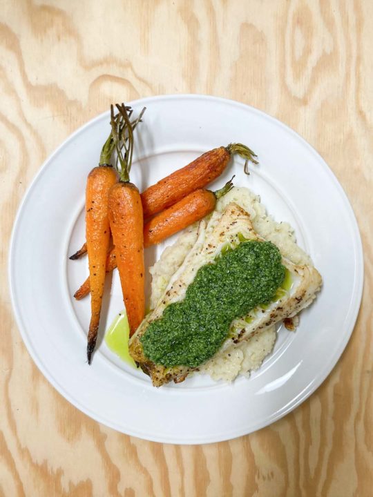 Pan-seared sablefish recipe with celeriac puree, roasted baby carrots and carrot greens pesto