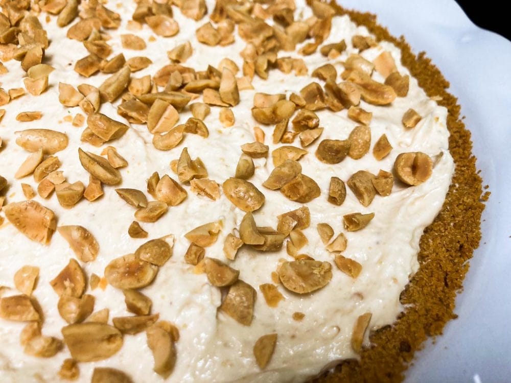 Peanut butter cream pie topped with chopped peanuts