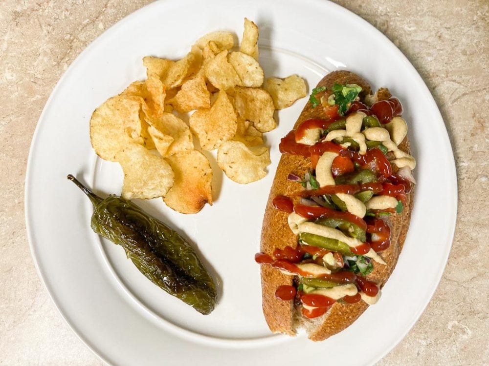 Sonoran hot dog with chips and jalapeno pepper