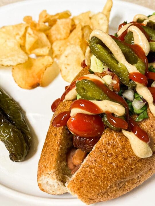 Sonoran hot dog with potato chips and grilled jalapeno pepper