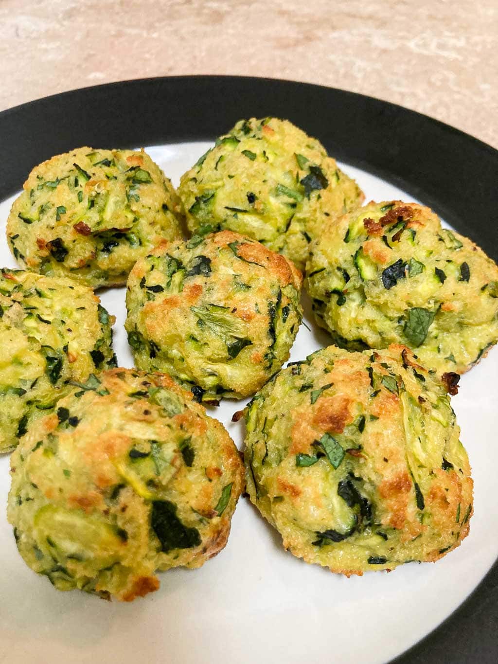 Baked zucchini summer squash balls on a plate