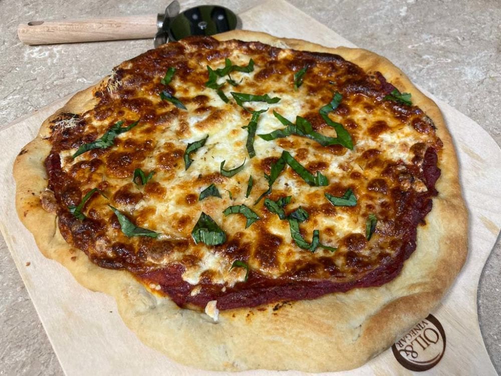 Delicious three cheese pizza recipe featuring mozzarella, parmesan and provolone