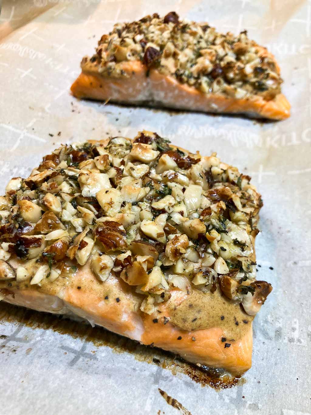 Hazelnut crusted coho salmon fillets on baking sheet