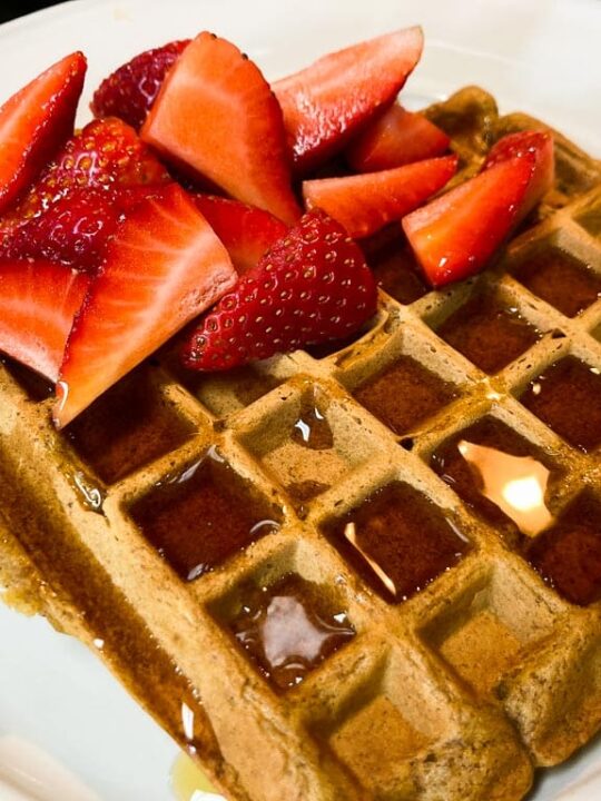 Pumpkin waffle with maple syrup and strawberries