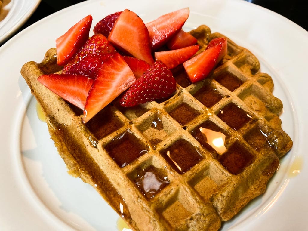 Pumpkin waffle with maple syrup and strawberries