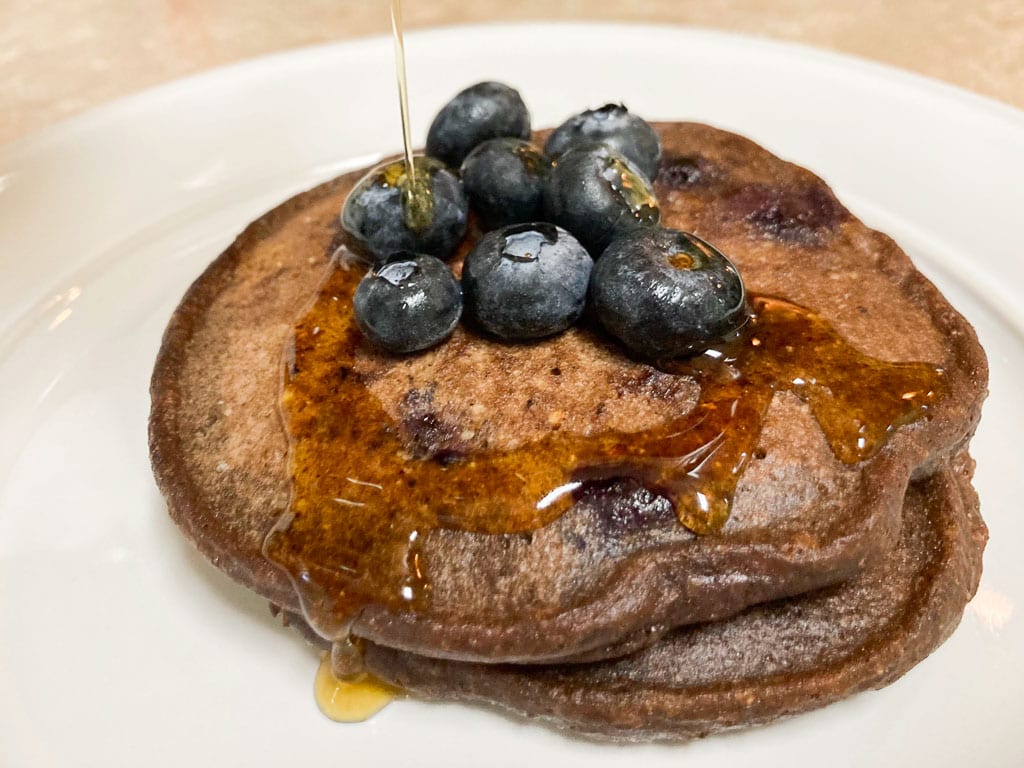 Wild rice pancakes with blueberries and a drizzle of maple syrup