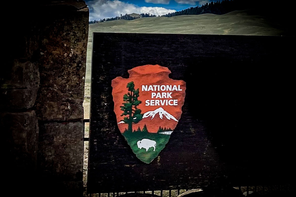 National Park Service Arrowhead logo on sign in Yellowstone National Park