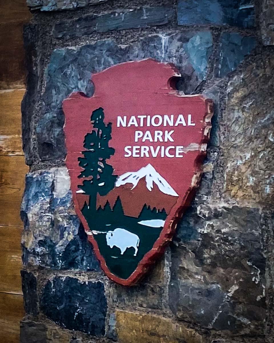 National Park Service Arrowhead symbol on Glacier National Park entrance sign