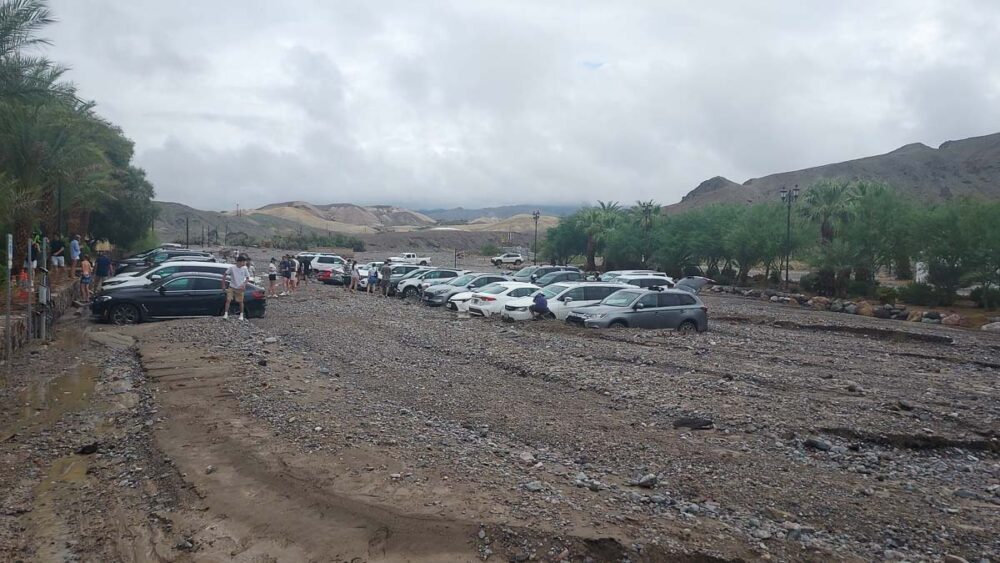 Cars at the Inn at Death Valley immobilized by debris following rain storms - Credit NPS