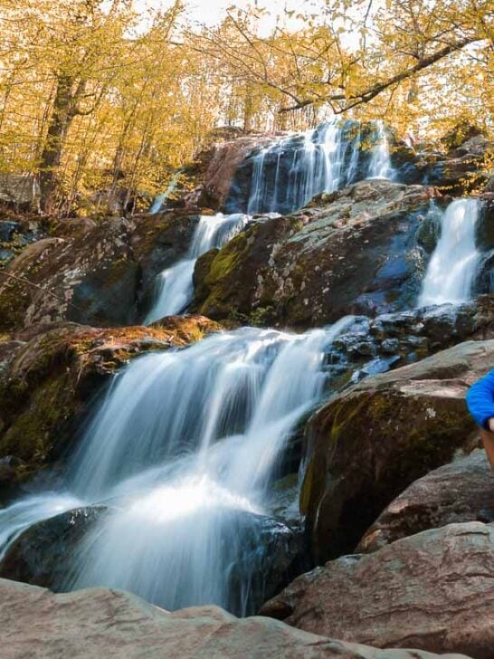 Hiker at Dark Hollow Falls in fall in Shenandoah National Park