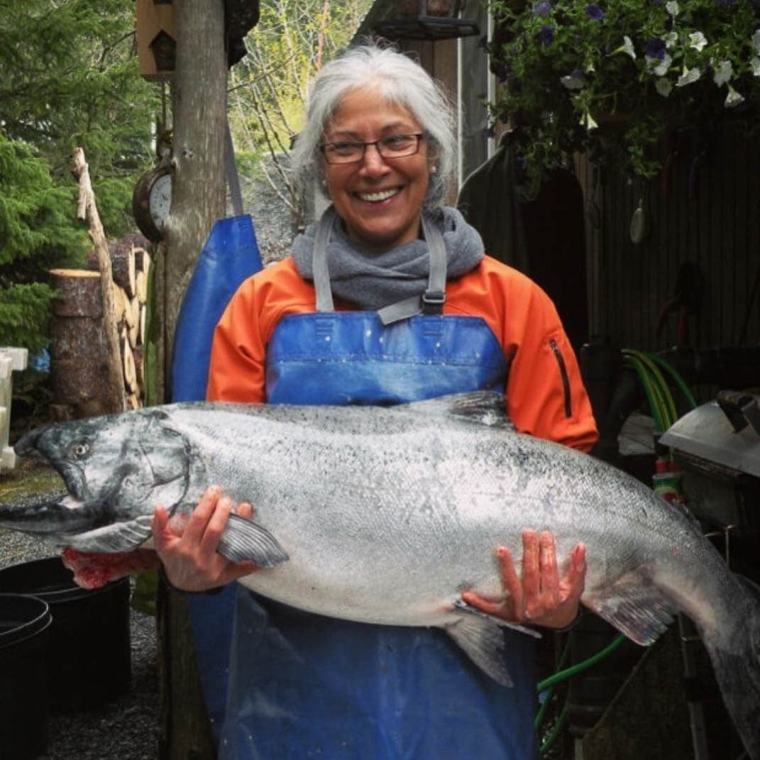Native Alaskan woman with fresh caught fish