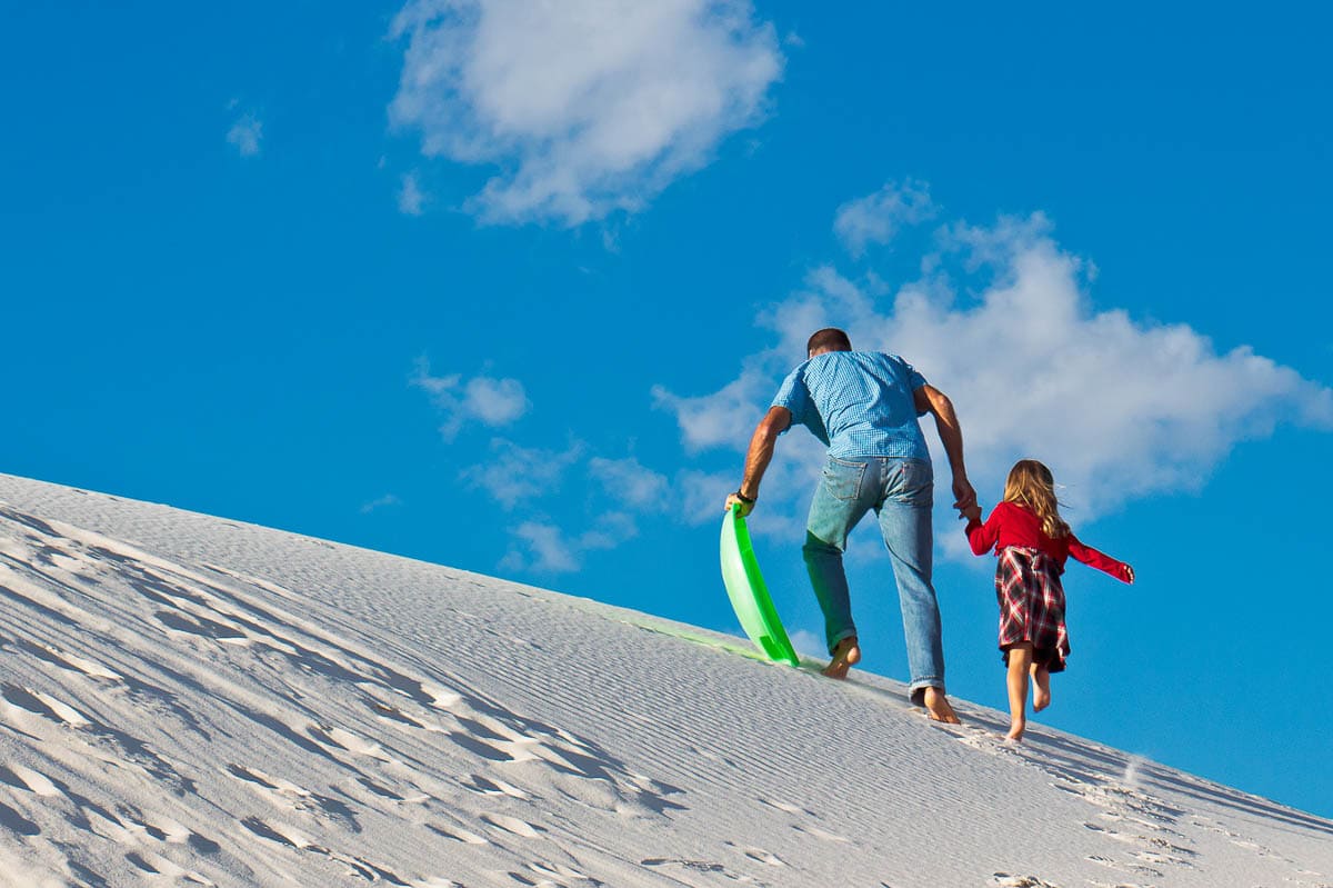 Sand sledding in White Sands National Park, New Mexico - Photo Credit NPS