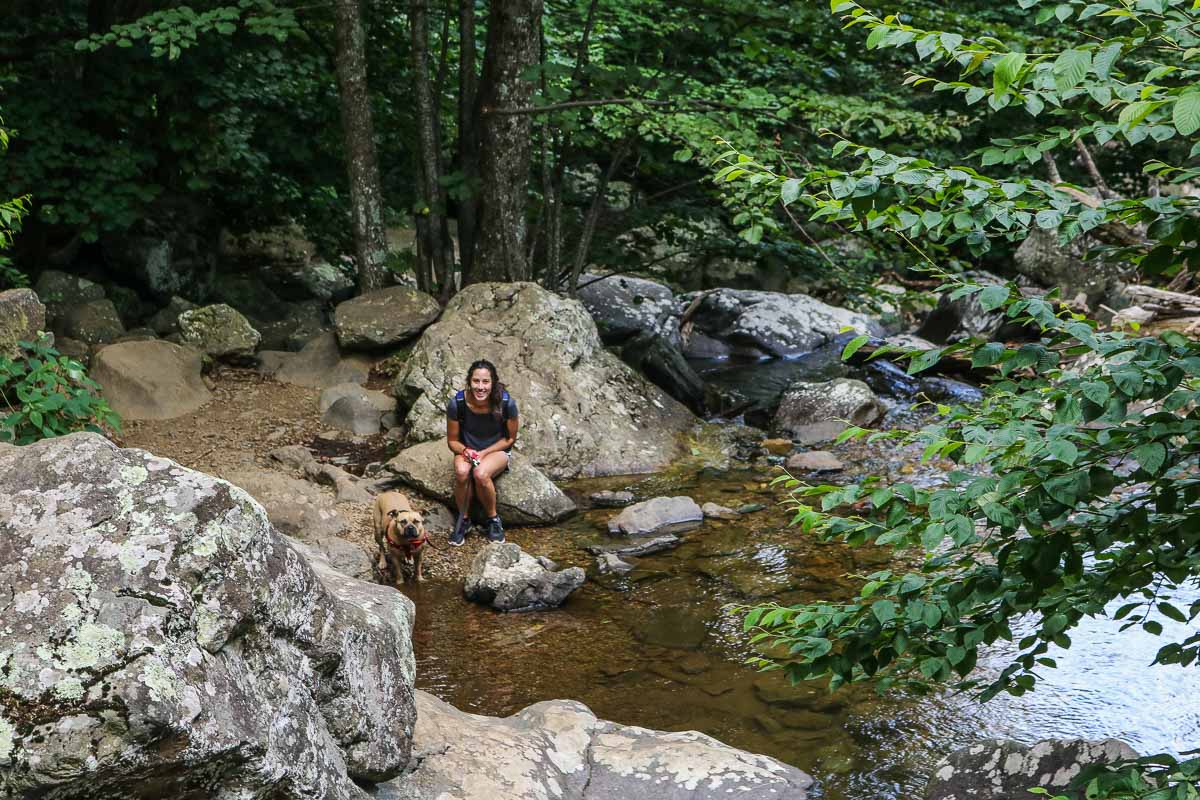 Hiker with her dog in the woods of Shenandoah National Park, Virginia