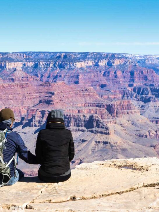 Couple holding hands while enjoying spectacular views in Grand Canyon National Park