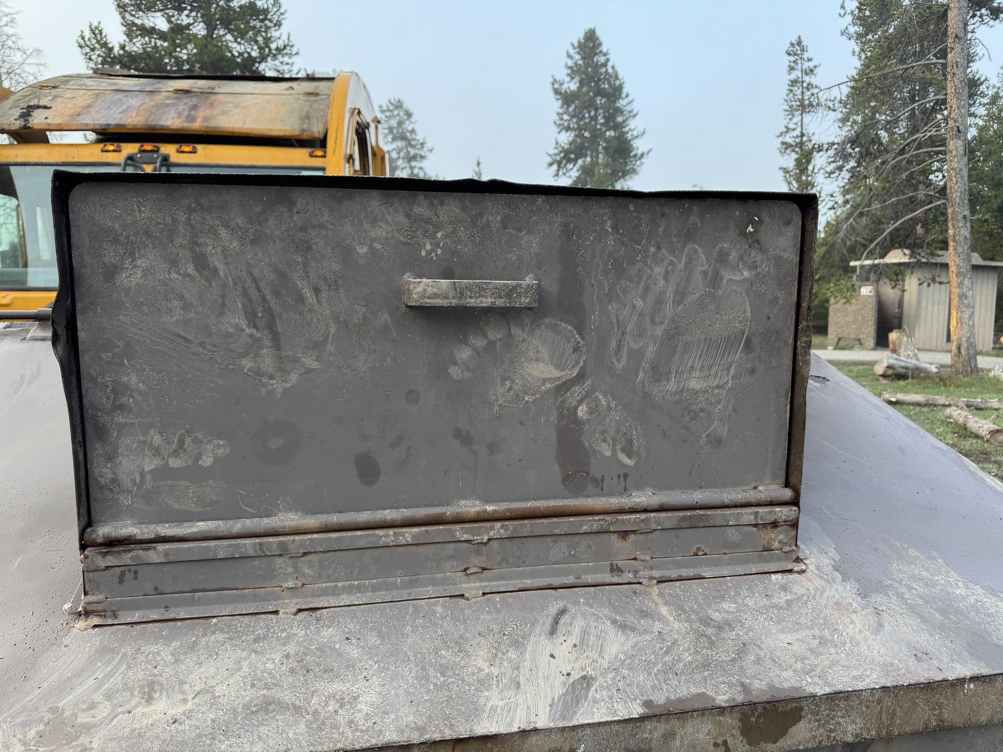 Grizzly paw prints on bear-resistant dumpster - Image credit: NPS / Allan Barker